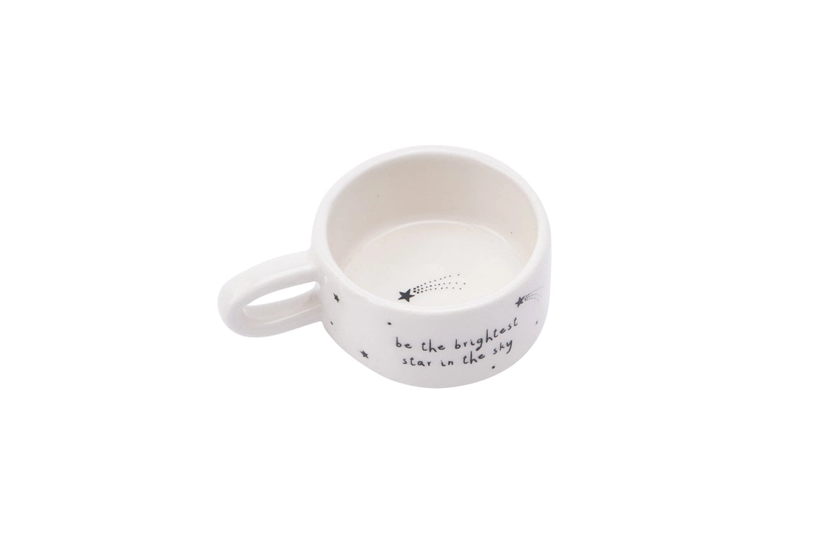 White ceramic candle holder with text on a white background