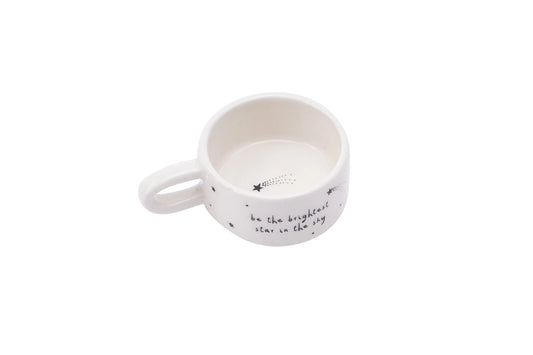 White ceramic candle holder with text on a white background