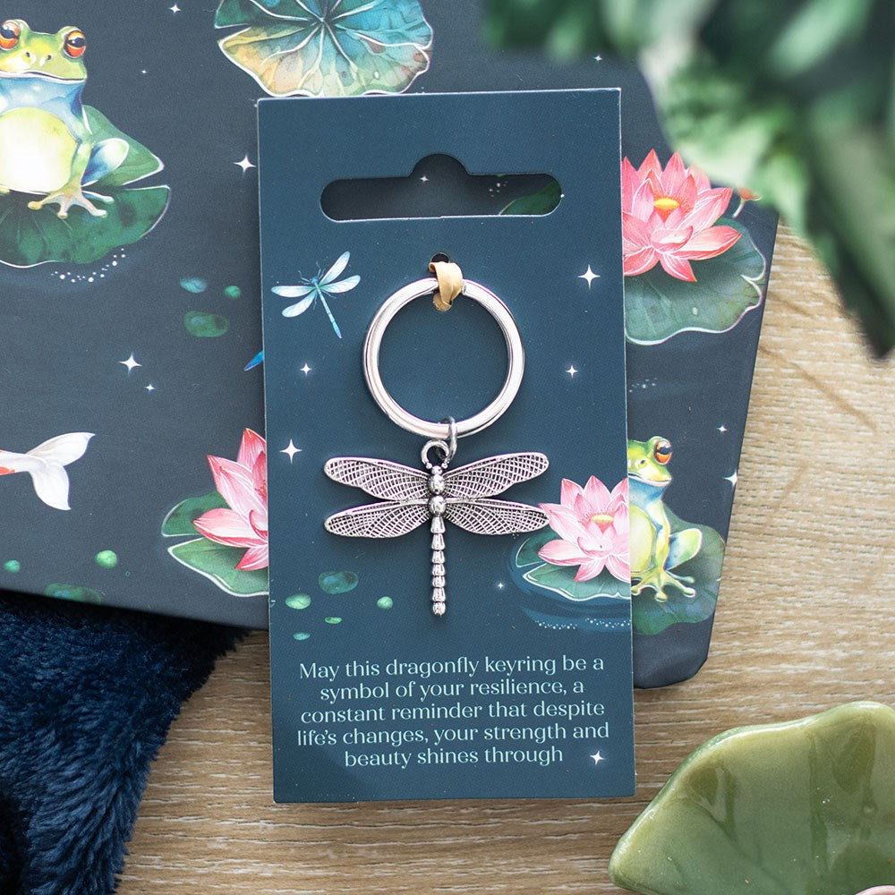 Dragonfly keychain on a decorative card with frog and lotus designs