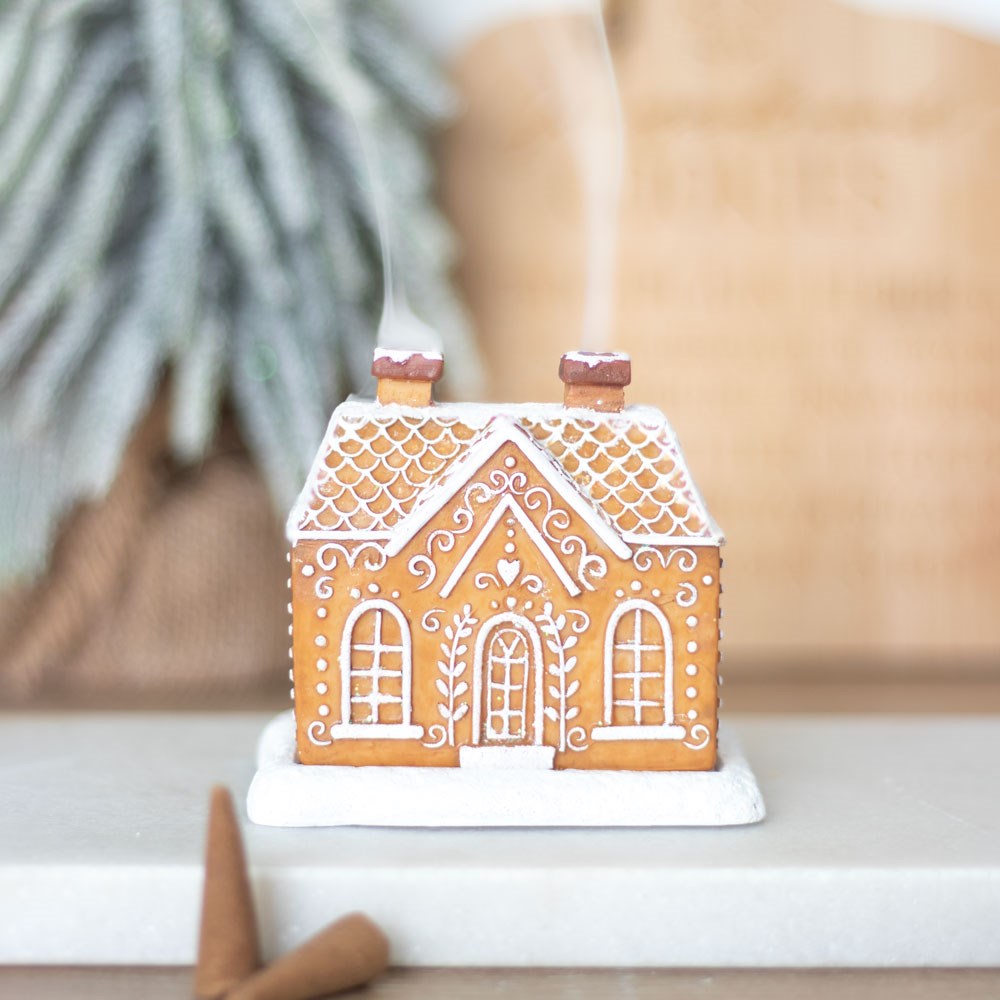 Gingerbread house incense cone holder, with glitter and white lines as decorations. Use with upwards flow incense cone. Smoke comes out of chimney.