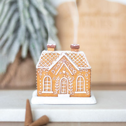 Gingerbread house incense cone holder, with glitter and white lines as decorations. Use with upwards flow incense cone. Smoke comes out of chimney.