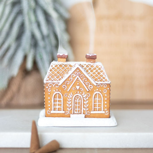 Gingerbread house incense cone holder, with glitter and white lines as decorations. Use with upwards flow incense cone. Smoke comes out of chimney.