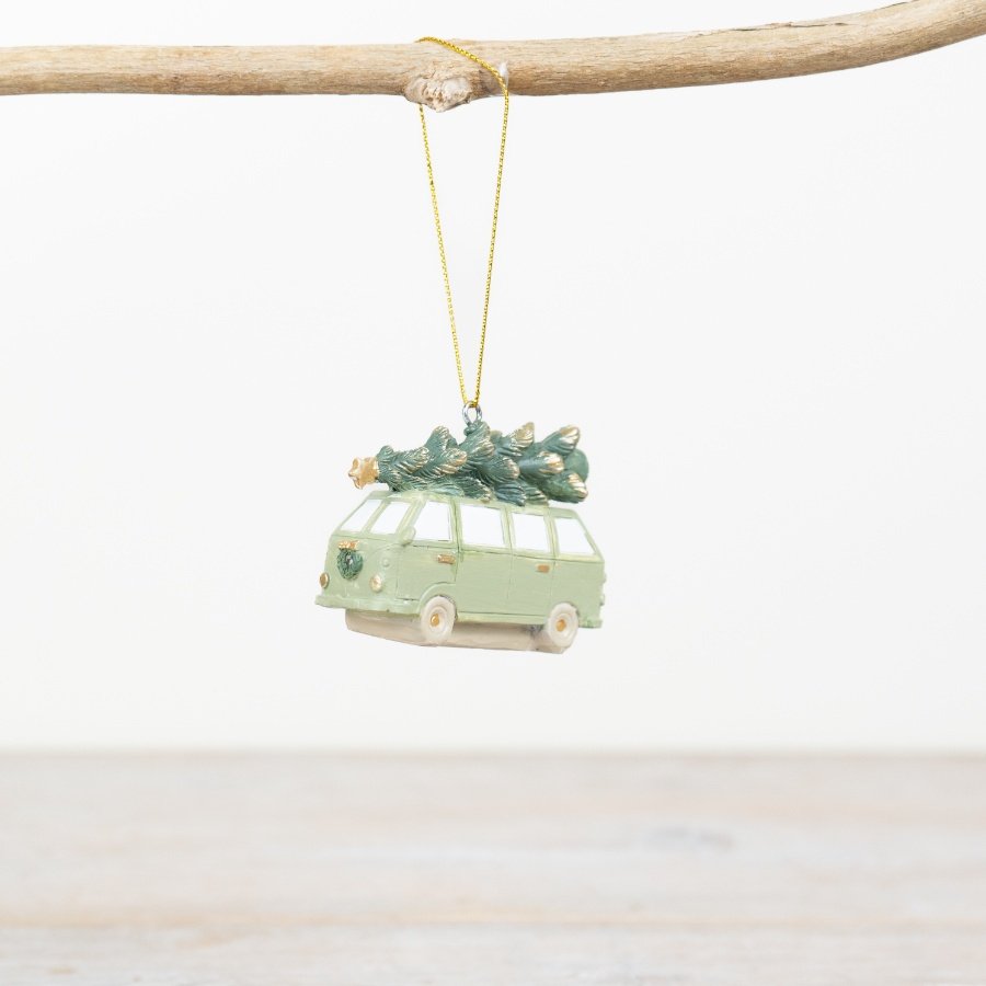 Decorative hanging ornament of a sage green van with Christmas tree on top of t.