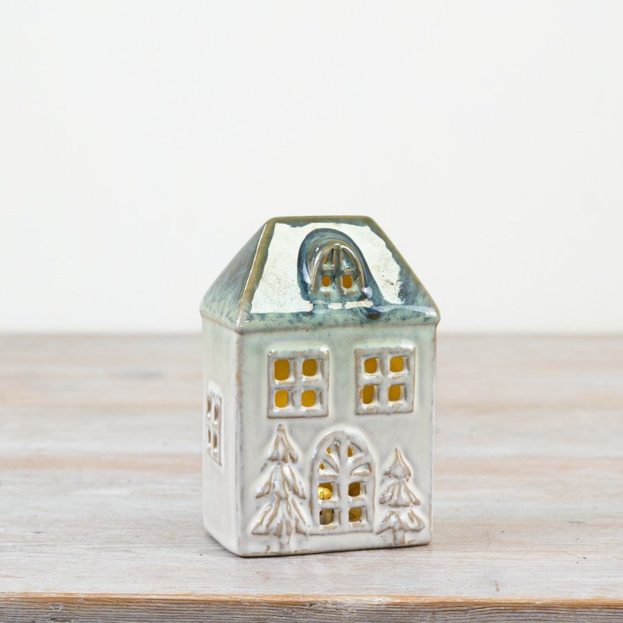 Ceramic house-shaped lantern with a white base and blue roof. 