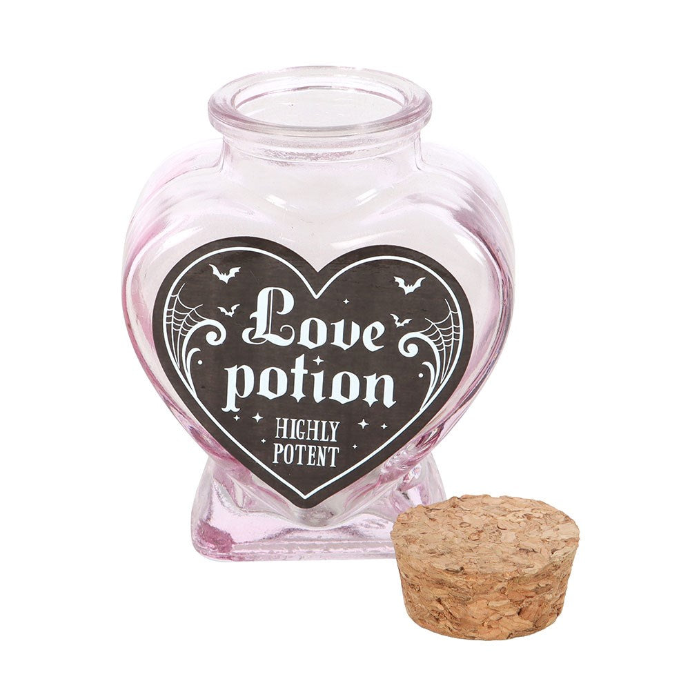 Heart-shaped glass jar or bottle  labeled 'Love potion Highly Potent' with a cork.