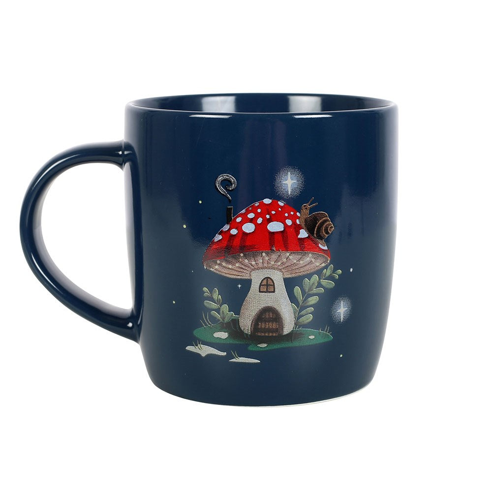 Navy blue mug with a red mushroom house design on a white background