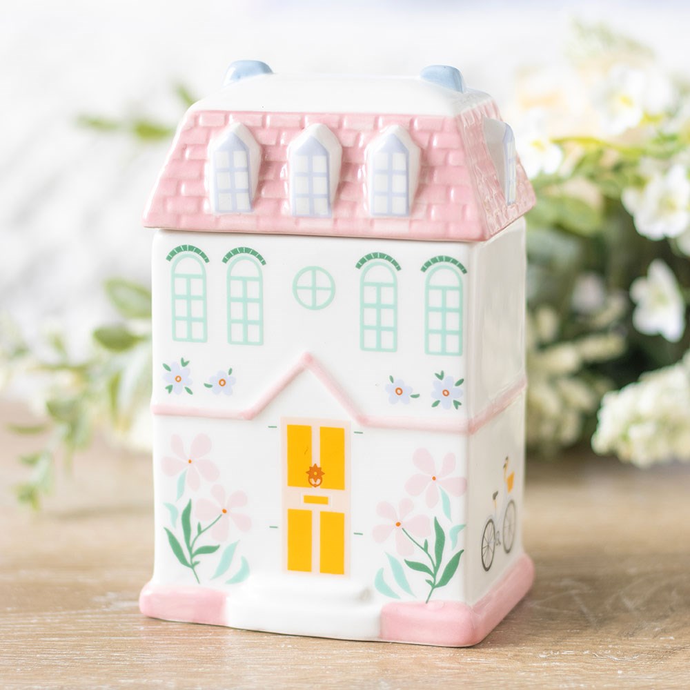 Pastel cute house oil burner or wax melter with lid. Pink pastel house design with print of windows, door, flowers.