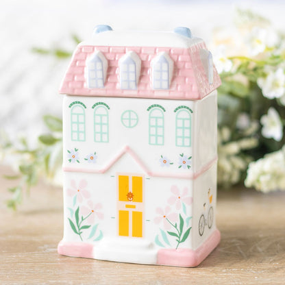 Pastel cute house oil burner or wax melter with lid. Pink pastel house design with print of windows, door, flowers.