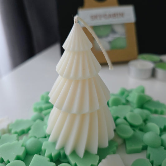 Tree-shaped candle on a bed of green wax melts.