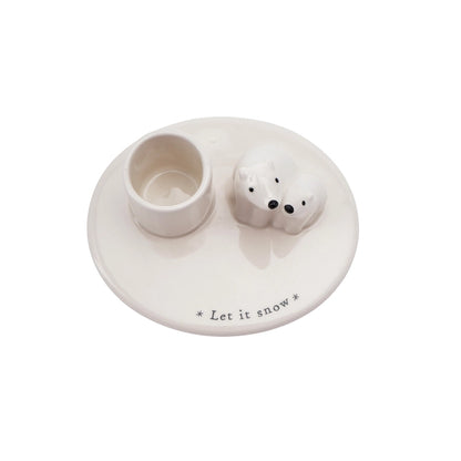 White ceramic holder with two small round containers and a text 'Let it snow' on a white background