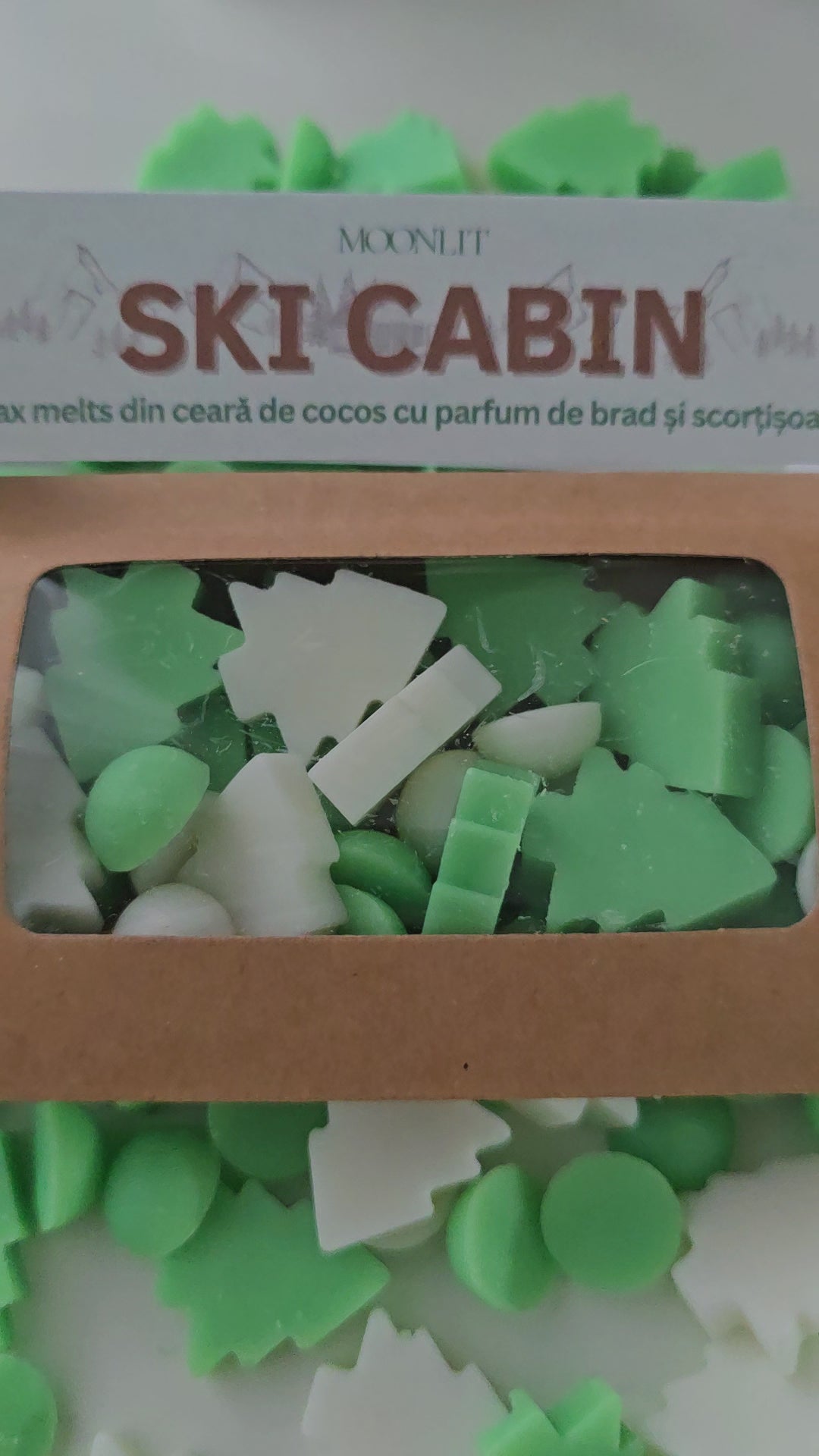 Ski cabin wax melts colored in white and green and shaped as christmas trees and dots.