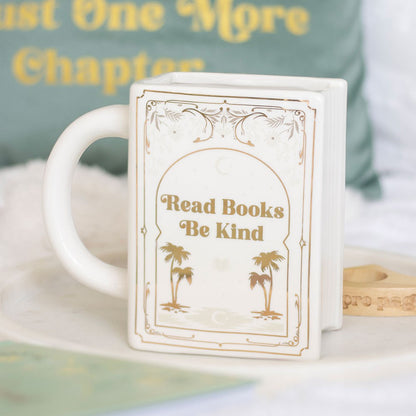 White coffee mug or tea cup with 'Read Books, Be Kind' text and palm golden trees. It can be used as bookish decor as well.