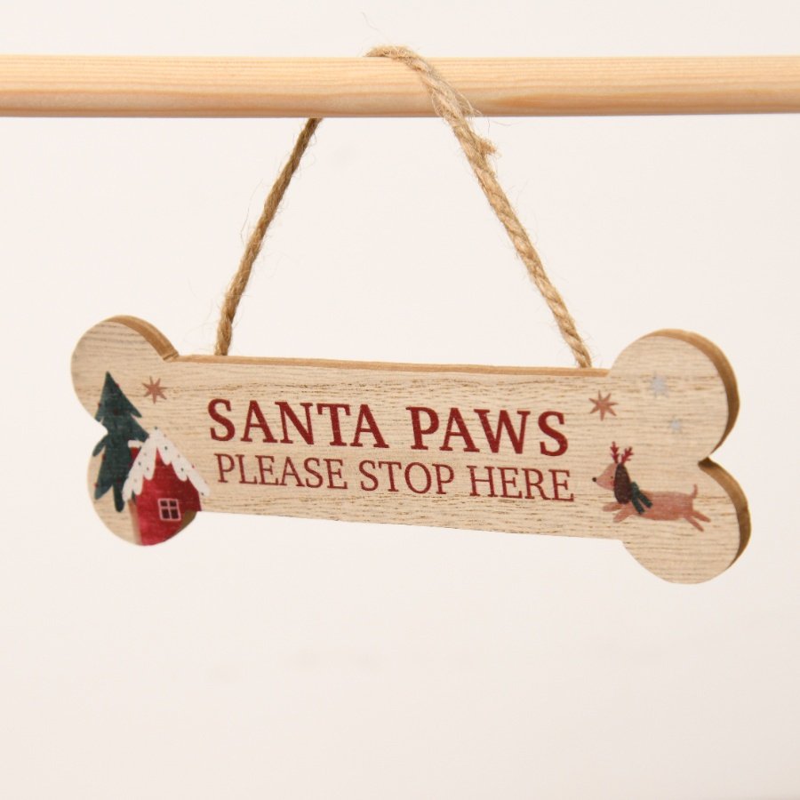 Wooden sign shaped like a dog bone with 'Santa Paws Please Stop Here' text and Christmas-themed illustrations.